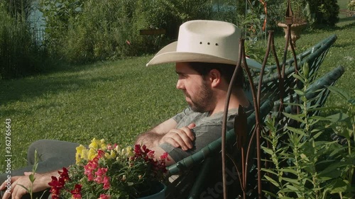 man in cowbow hat relaxing in summer photo