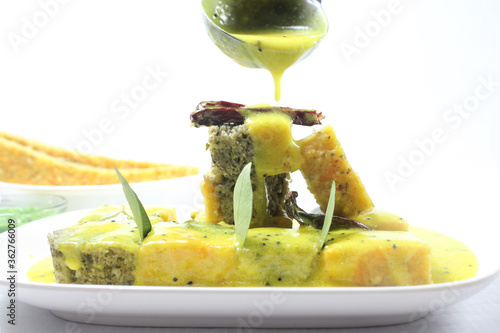 Sandwich Khaman or Sandwich Dhokla is an Indian Popular snack Originated in Gujarat.Served with chutney and kadhi photo