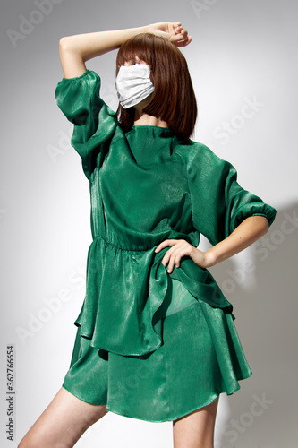 Fashion female coronavirus, model posing with gloves and protective medical mask