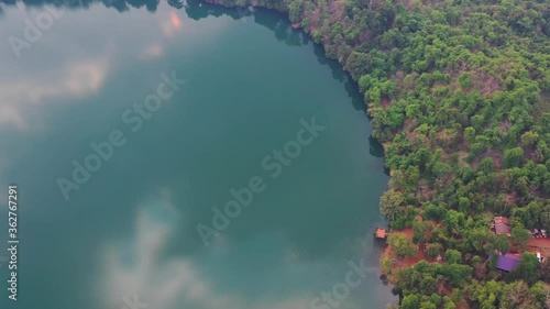 Forest trees in the Yeak laom lake. A peaceful place in the green jungle of Cambodia photo