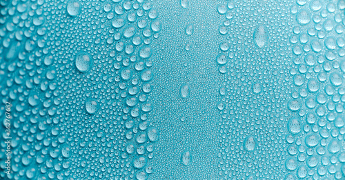 water drops of dew on painted metal surface macro background