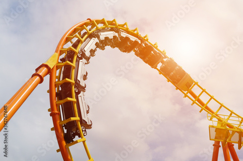 Roller coaster in the amusement park with the sunset background.