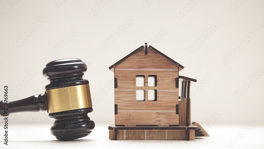 House model with a judge gavel. House model with a judge gavel.