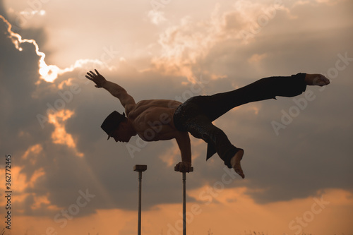 performance of an aerialist outdoors during sunset. © Andrey