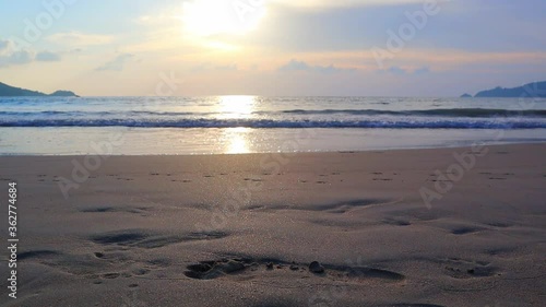 Wallpaper Mural Reflection of sun and shadow of a man walking on the beach at Patong Beach, Phuket, Thailand Torontodigital.ca