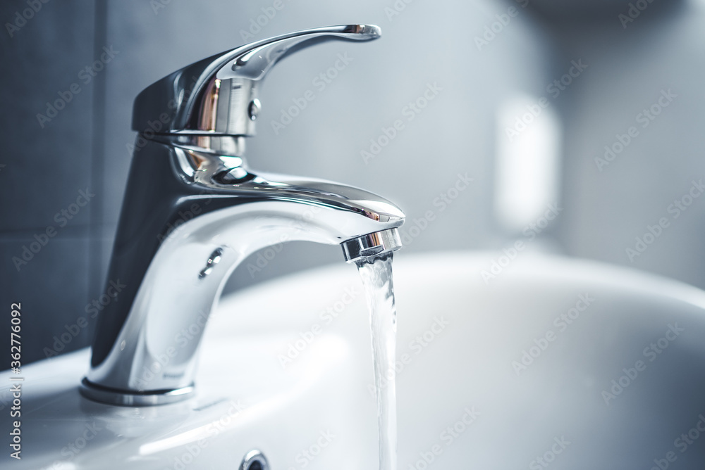 Water tap , faucet. Flow water in bathroom with sink. Modern clean hause.  Backround hygiene. Stock Photo | Adobe Stock