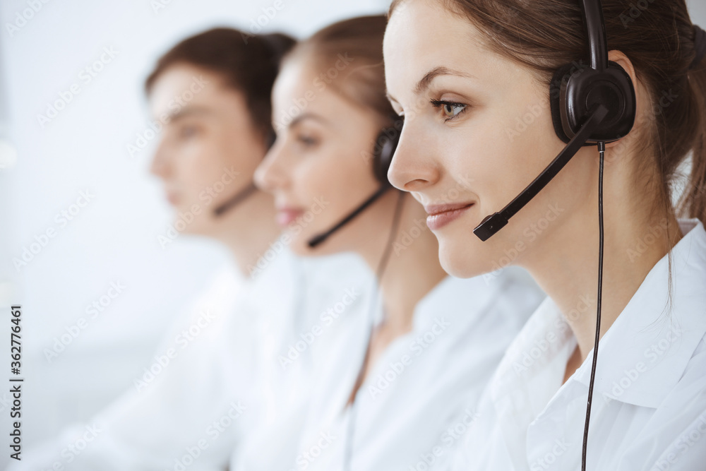 Call center. Beautiful young woman using headset and computer to help customers. Business concept Call center. Beautiful young woman using headset and computer to help customers. Business concept