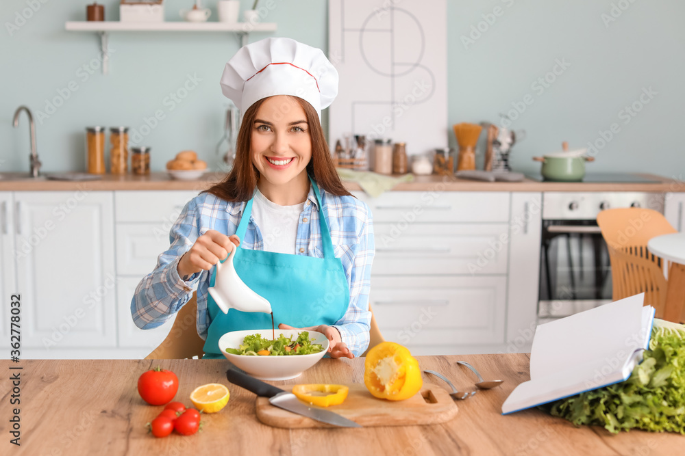 Young woman making tasty salad in kitchen Young woman making tasty salad in kitchen
