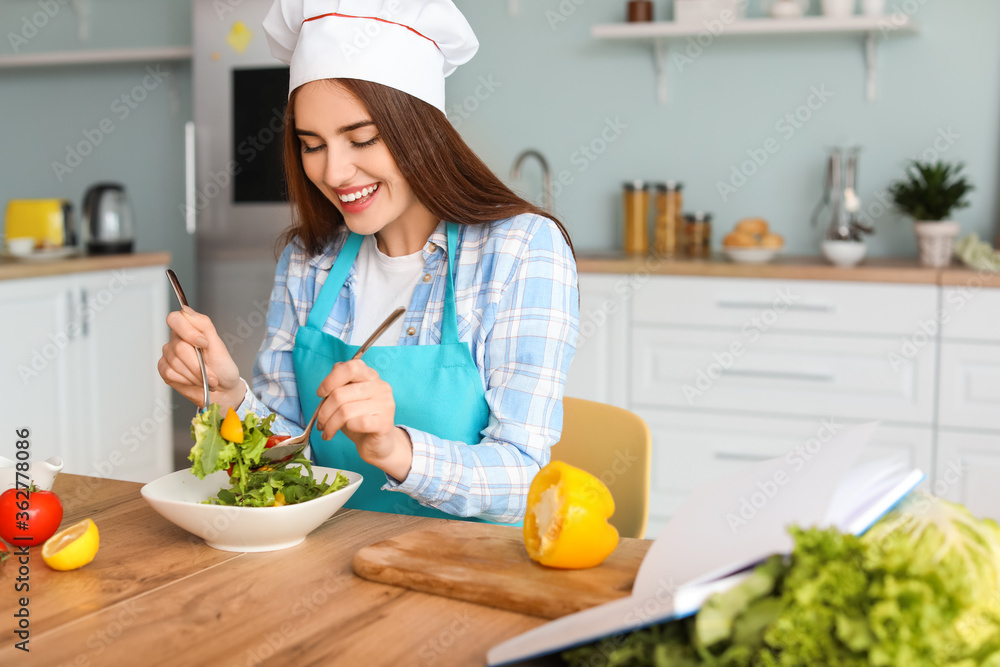 Young woman making tasty salad in kitchen Young woman making tasty salad in kitchen