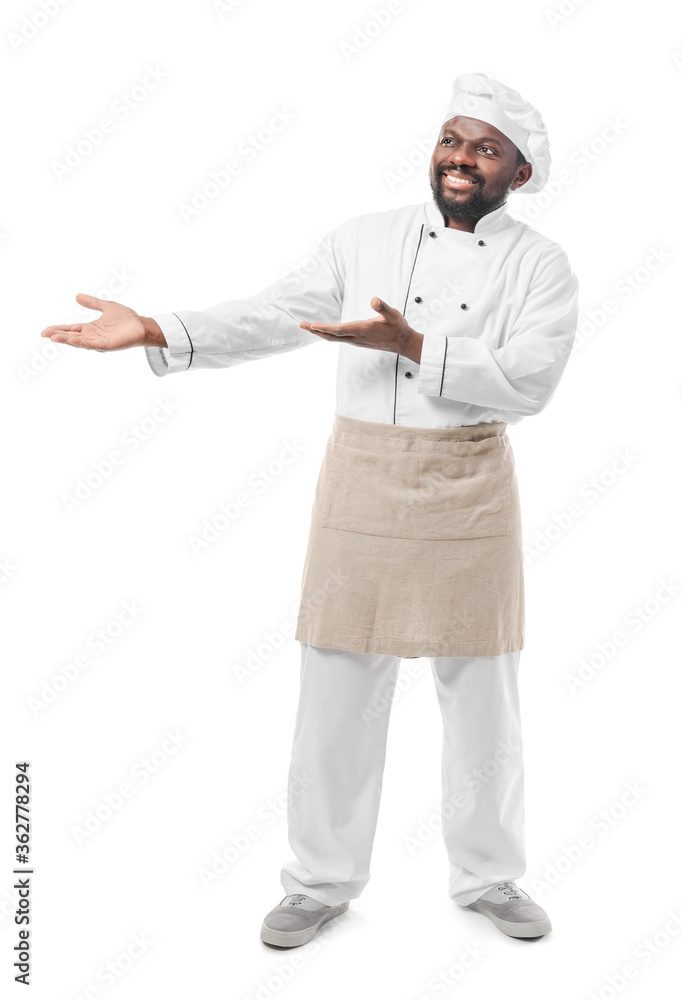 Male African-American chef showing something on white background Male African-American chef showing something on white background