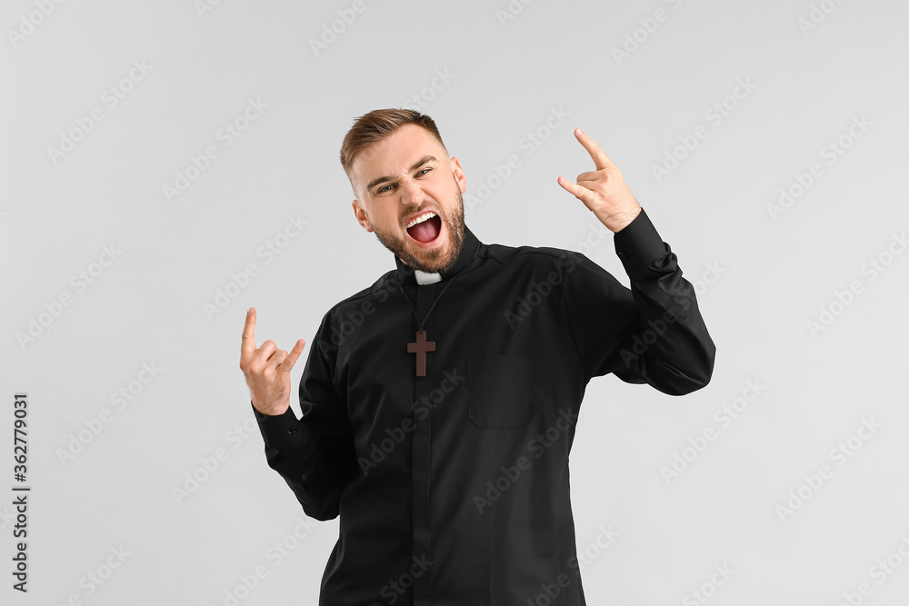 Cool young priest on light background Cool young priest on light background