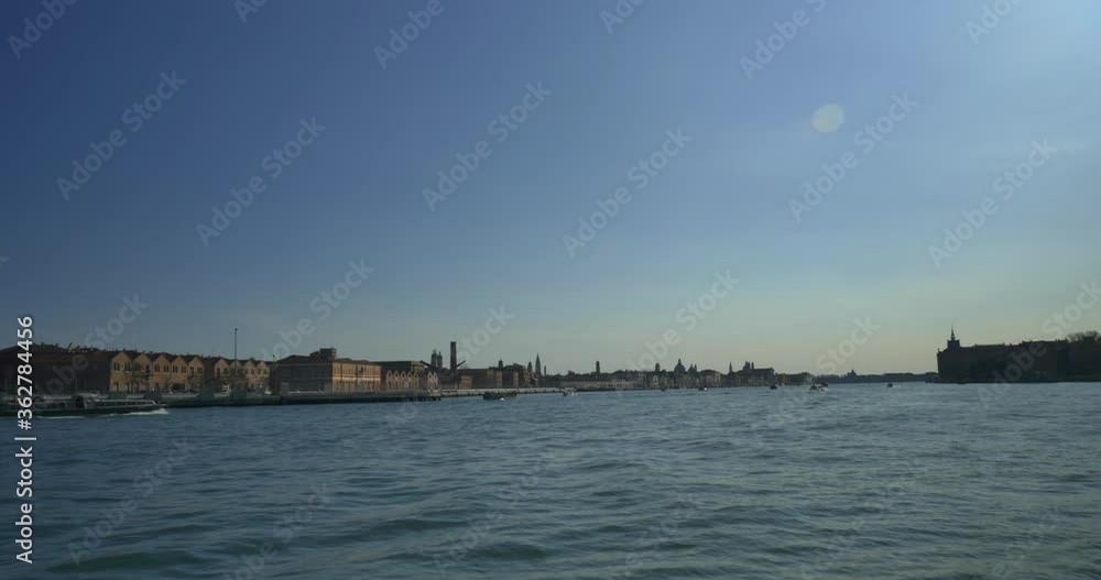 view of Venice grand canal from boat travelling through on a bright sunny day view of Venice grand canal from boat travelling through on a bright sunny day