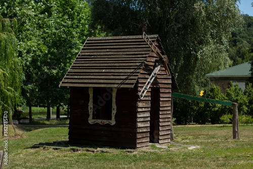 wooden house in the summer park © dyachenkopro