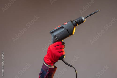 Hand with an electric drill...