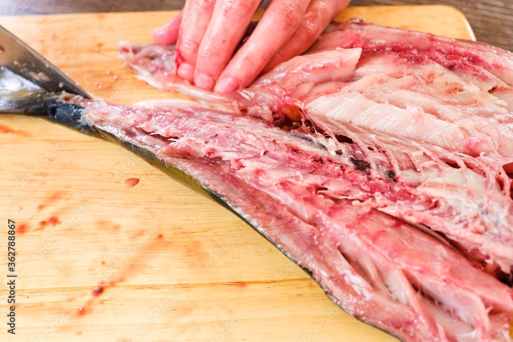 Cutting raw fish tuna food, background meal.