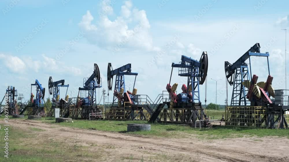 Oil derricks against cloudy sky Oil derricks against cloudy sky