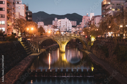 Meganebashi Bridge in the evening. It is often called Spectacles Bridge and it is the most remarkable of several stone bridges that span the Nakashima River in Nagasaki.  photo
