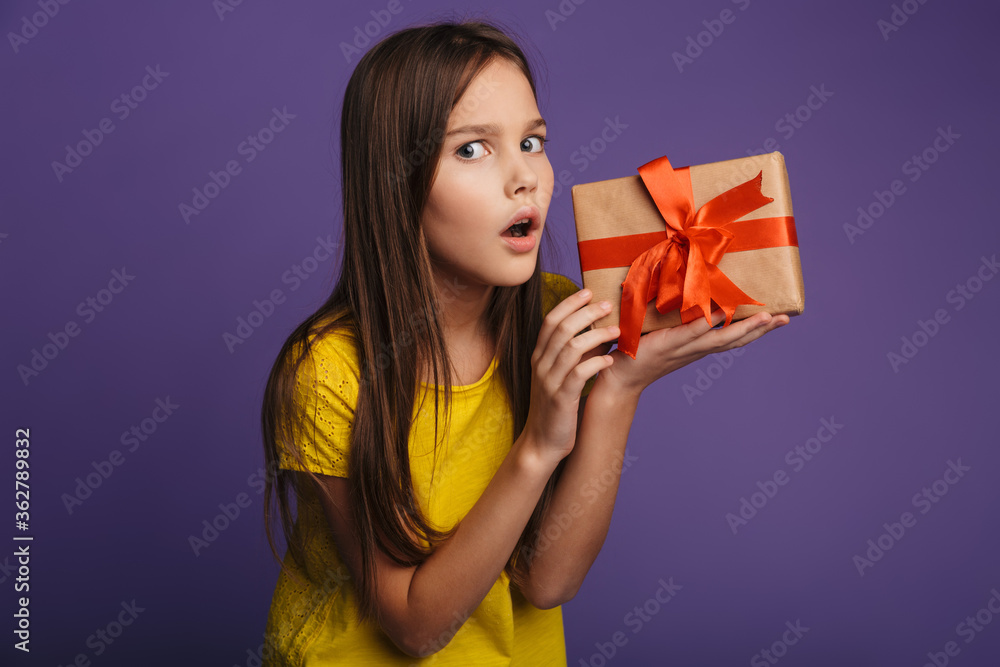 Photo of nice beautiful girl holding gift box and expressing shock Photo of nice beautiful girl holding gift box and expressing shock
