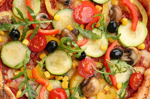 Delicious hot vegetable pizza with mushrooms as background, closeup