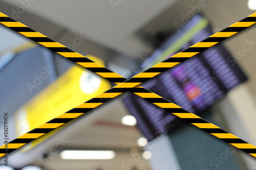 Danger, caution tape at the closed airport due to Coronavirus, Covid19