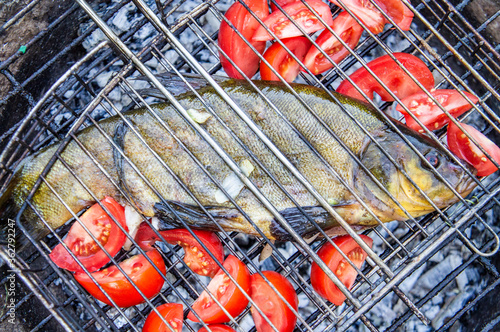 Bild auf Leinwand Barbecue tench fish with sun-dried tomatoes