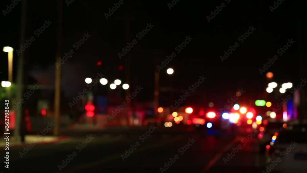 Out of focus red and blue lights on a city street at night Out of focus red and blue lights on a city street at night