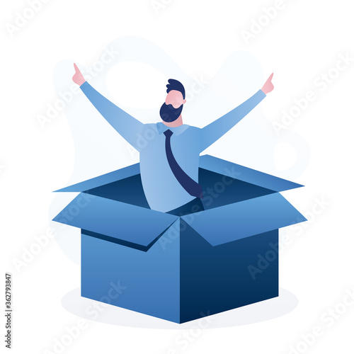 Happy man in an opened cardboard box. Successful businessman in box. Job seeker or developer of new startup product.