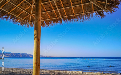 Fototapeta Naklejka Na Ścianę i Meble -  Sunshade on sunny beach of the Red Sea, Middle East