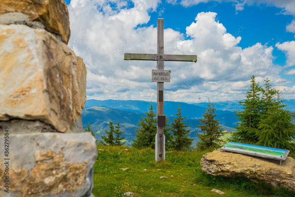 Wooden religious cross on the top of a hill in Austria. Grebenzen Dreiwald kogel close to Sankt Lambrecht ion a sunny and cloudy weather. Wooden religious cross on the top of a hill in Austria. Grebenzen Dreiwald kogel close to Sankt Lambrecht ion a sunny and cloudy weather.