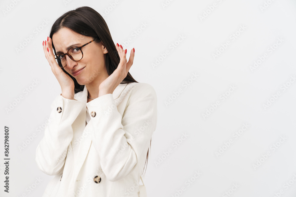 Photo of confused businesswoman covering her face and looking at camera Photo of confused businesswoman covering her face and looking at camera