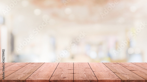 Empty wood table top and blurred coffee shop and restaurant interior background - can used for display or montage your products.