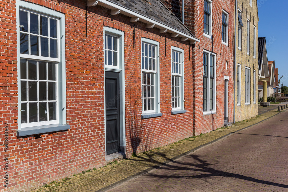 Colorful old dutch houses in historic village Makkum, Netherlands
