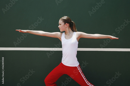 Woman exercising in the tennis court