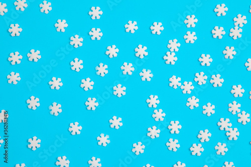 background, sweet topping for a cake in the shape of a snowflake on a blue background