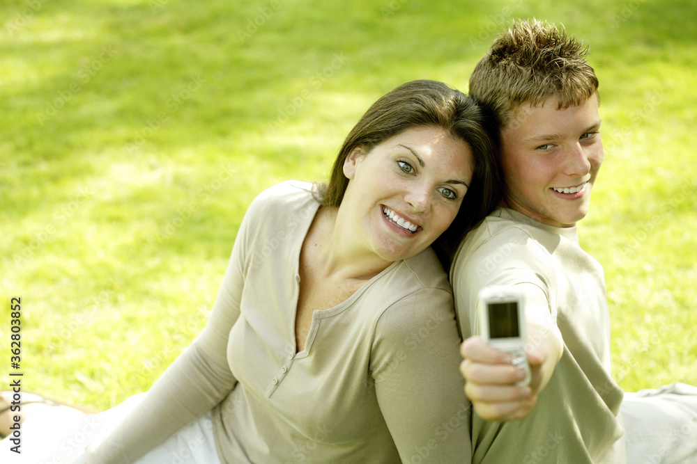 Mother and son taking picture with camera phone Mother and son taking picture with camera phone