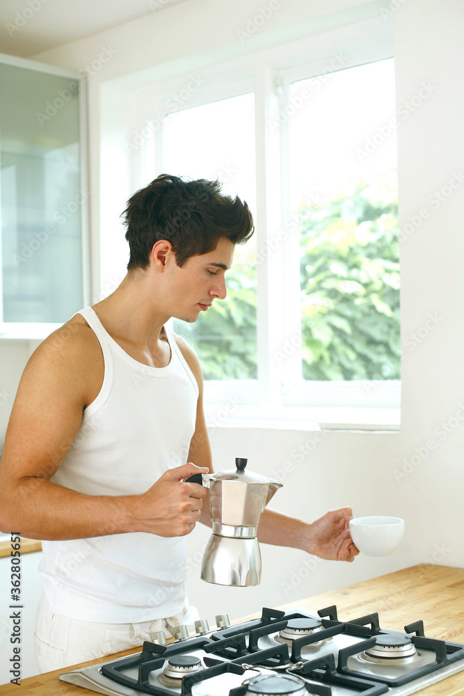 Man holding a teapot and a teacup