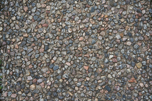 Photo of crushed stone and gravel on the ground. Texture background white gray stones on a black earth background. Image of broken stones