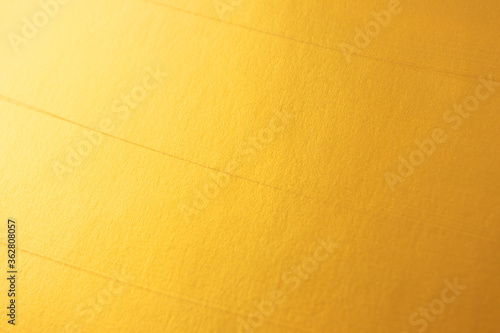 Golden defocused bright textured backgound. Elegant and luxury gold color abstract wallpaper photo