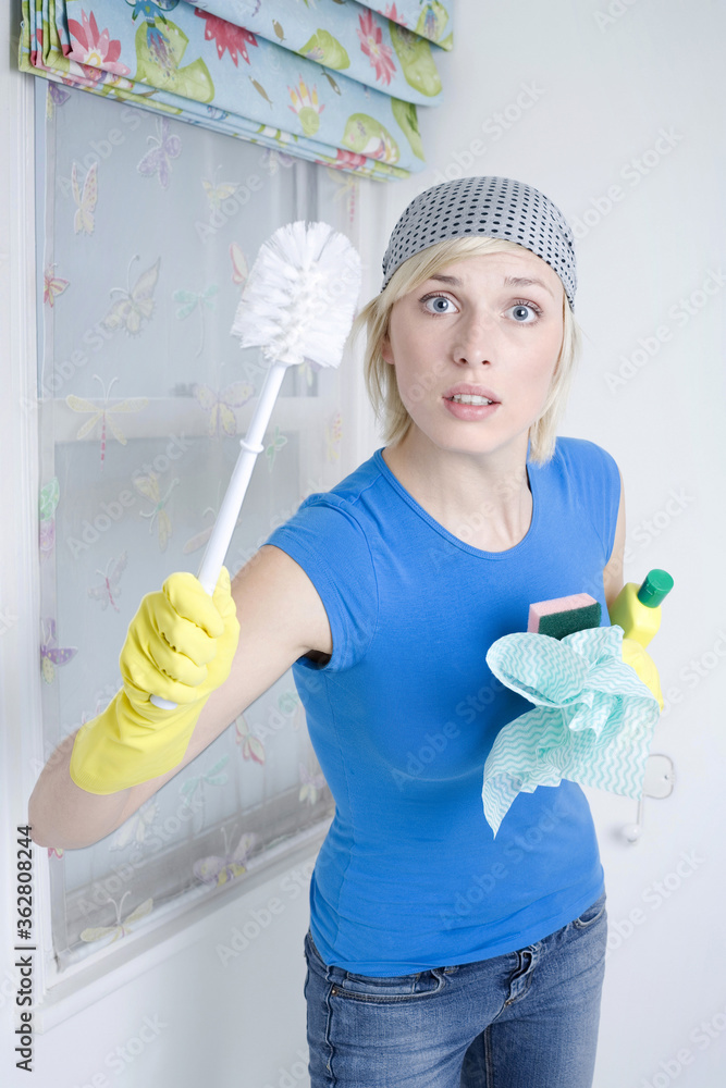 Woman with rubber gloves holding cleaning equipment Woman with rubber gloves holding cleaning equipment