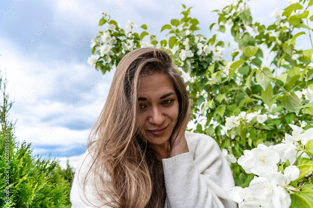 photo of a beautiful young girl with jasmine, summer photo of a beautiful young girl with jasmine, summer