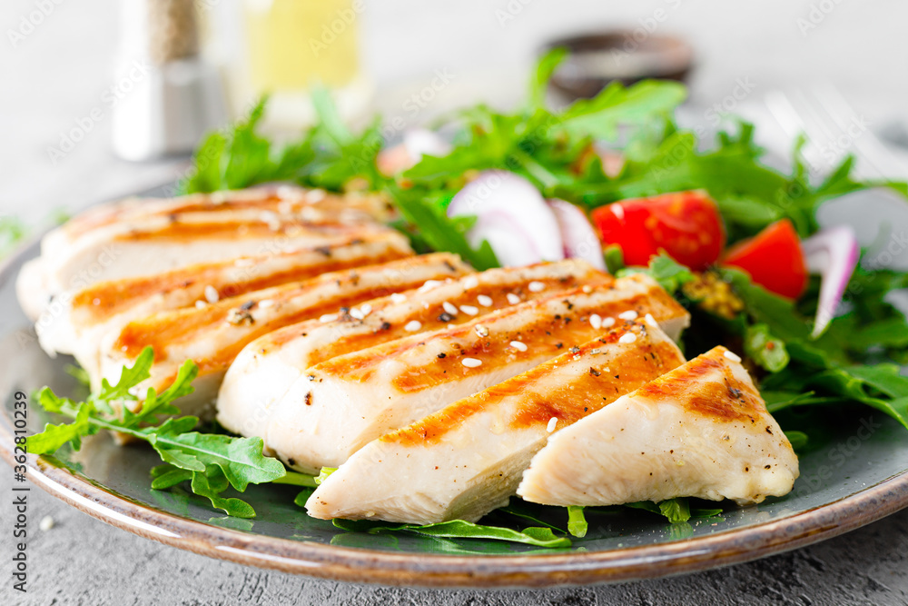 Chicken fillet salad with fresh vegetables and arugula. Fresh vegetable salad of arugula, tomatoes, onion and grilled chicken breast. Chicken fillet salad with fresh vegetables and arugula. Fresh vegetable salad of arugula, tomatoes, onion and grilled chicken breast.