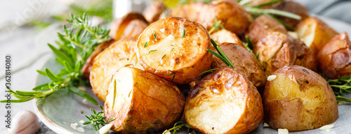 Baked potatoes with rosemary, thyme and garlic. Banner