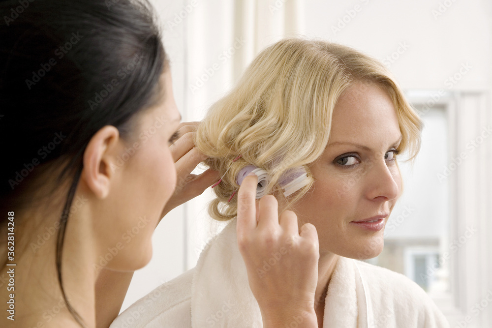 Woman getting her hair curled Woman getting her hair curled