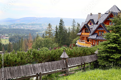 Fototapeta Naklejka Na Ścianę i Meble -  Guest house in the traditional mountain style and mountain landscape. Not far from Zakopane. Tatra mountains. Poland.