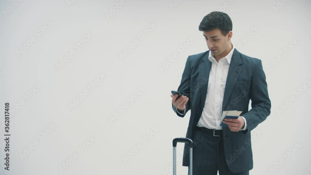 4k video of a handsome young man talking on the phone while waiting for his flight. 4k video of a handsome young man talking on the phone while waiting for his flight.