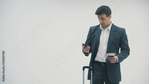 4k video of a handsome young man talking on the phone while waiting for his flight.