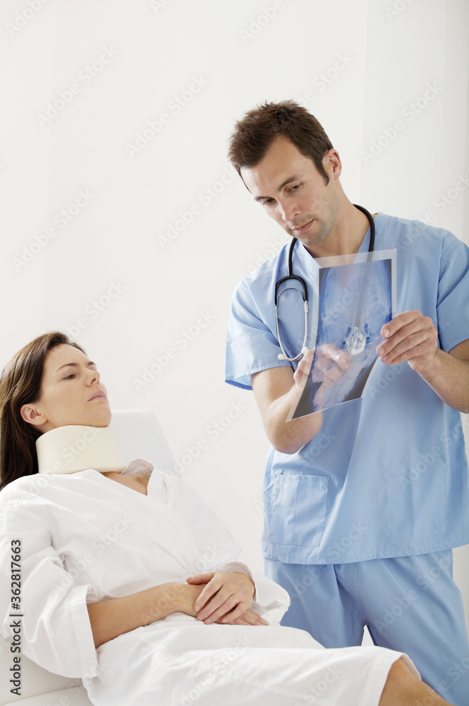 Male doctor treating a patient Male doctor treating a patient