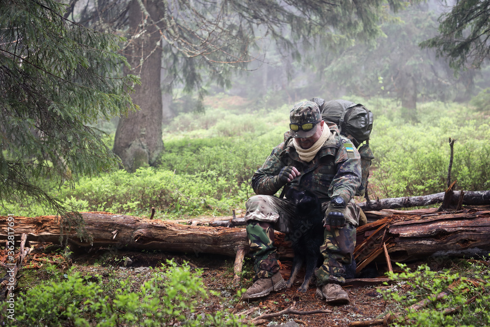 Active healthy man hiking and resting in beautiful forest