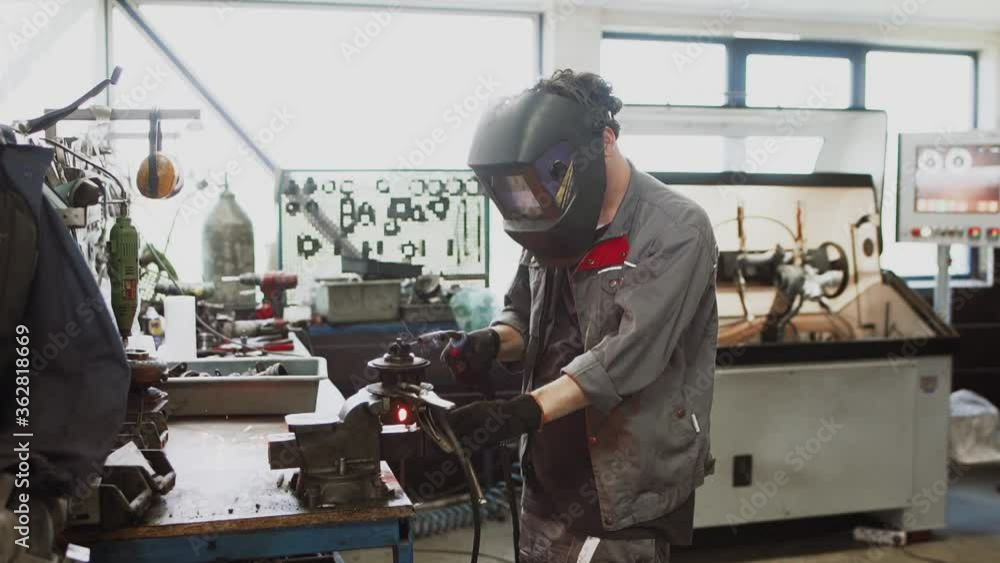 Auto mechanic repairing a car in a workshop.car repair concept Auto mechanic repairing a car in a workshop.car repair concept