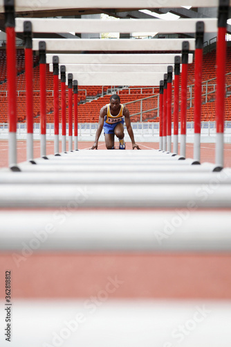Man getting ready to jump hurdles